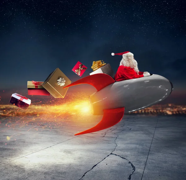 Santa claus delivers gifts with a fast space rocket — Stock Photo, Image