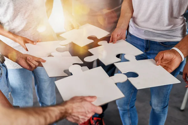 Teamwork of partners connect puzzle pieces as integration and startup — 图库照片