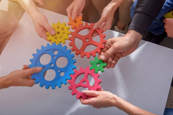 Business team connect pieces of gears like a teamwork and partners — Stock Photo, Image