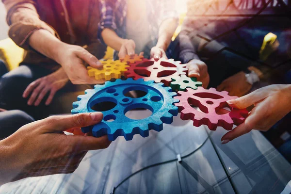 Business team connect pieces of gears like a teamwork and partners — Stockfoto