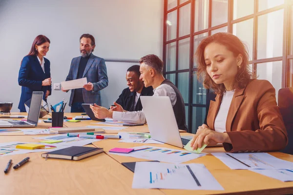 Grupo de empresarios tienen una reunión sobre las estadísticas de la empresa —  Fotos de Stock