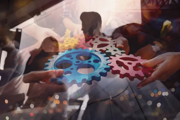 Business team connect pieces of gears like a teamwork and partners — Stock Photo, Image