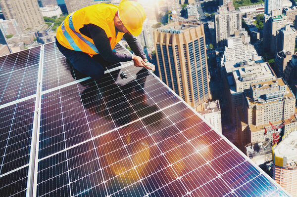 Workers assemble energy system with solar panel for electricity Stock Image