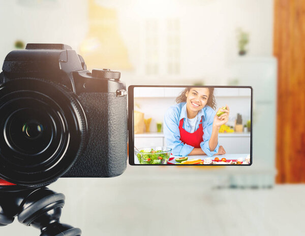 Vlogger woman chef records a video of cooking recipe Royalty Free Stock Images