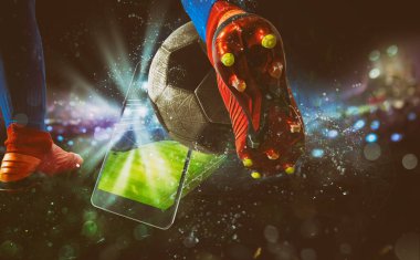 Soccer player, cellphone and ball on a stadium clipart
