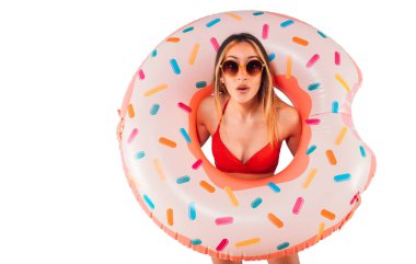 Amazed woman with inflatable donut in hand isolated on white background
