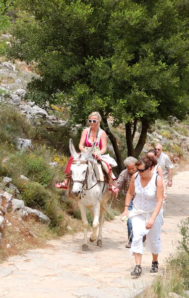 CRETE ISLAND, GREECE - MAY 13: The female tourist on a donkey an