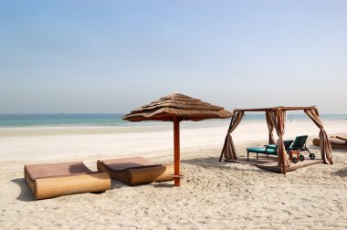 Beach with hut and sunbeds of the luxury hotel, Ajman, UAE clipart