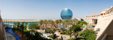 The panorama of luxury hotel and circular building, Abu Dhabi, U clipart
