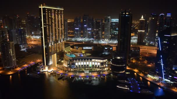 DUBAI, UAE - SEPTEMBER 8: The night illumination of Dubai Marina on September 8, 2013 in Dubai, UAE. It is an artificial canal city, built along a two mile (3 km) stretch of Persian Gulf shoreline. — Stock Video
