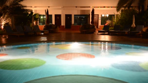 The swimming pool with jacuzzi at luxury hotel in night illumination, Ajman, UAE — Stock Video