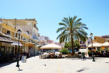 KALAMATA, GREECE - JUNE 7: The outdoor tavern with local inhabit clipart