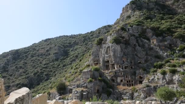 Panning down the rock-cut túmulos in Myra, Antalya, Turquia — Vídeo de Stock