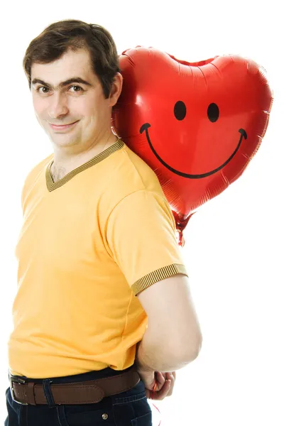 Joven sosteniendo un globo rojo en forma de corazón —  Fotos de Stock