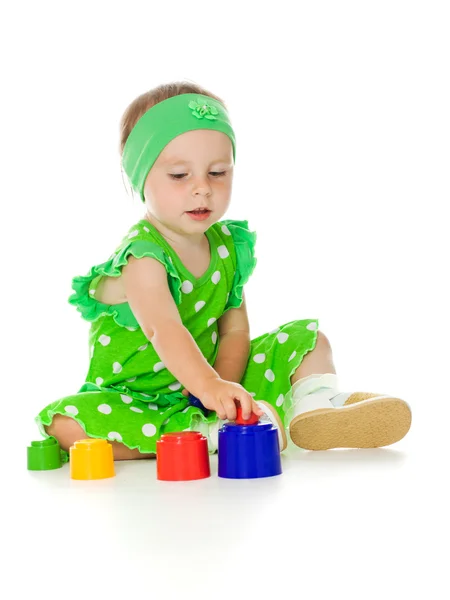 Little girl is playing with toy pyramid — Stock Photo, Image