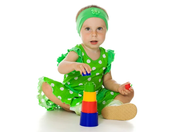 Little girl is playing with toy pyramid — Stock Photo, Image