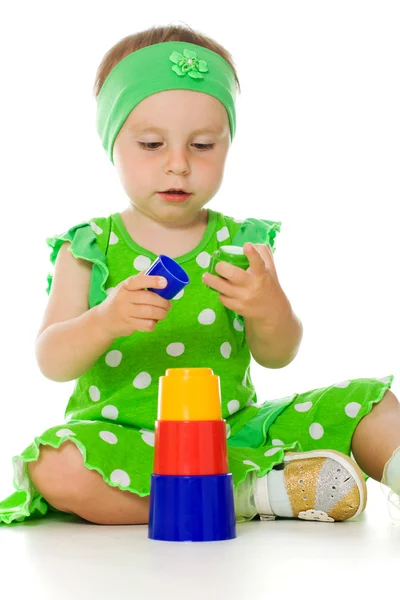 Little girl is playing with toy pyramid — Stock Photo, Image