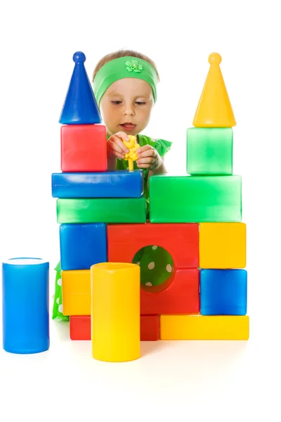 Little girl is playing with toy cubes — Stock Photo, Image