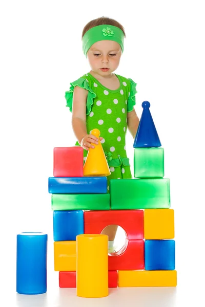 Little girl is playing with toy cubes — Stock Photo, Image