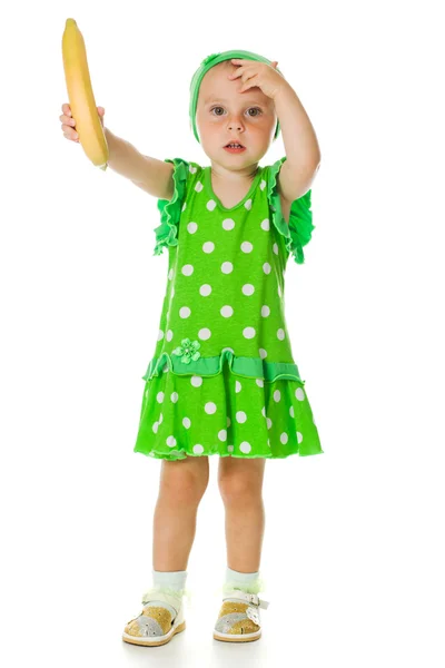 Young little girl with a banana — Stock Photo, Image