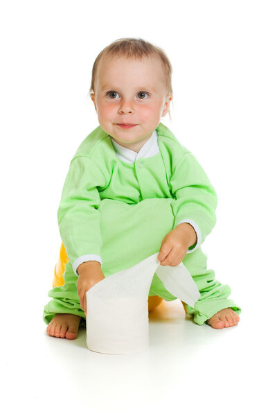 Child on potty play with toilet paper