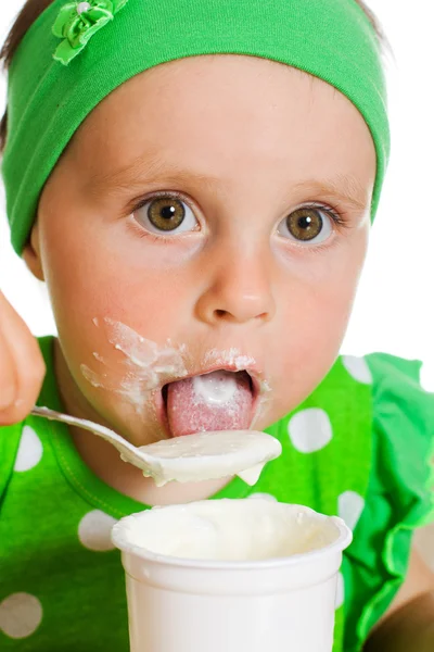 Girl eats with a spoon dairy product. — Stock Photo, Image