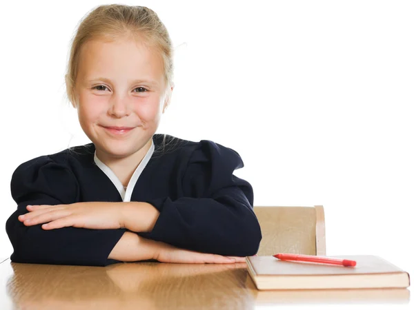 Schoolgirl is sitting at his desk — Stock Photo, Image