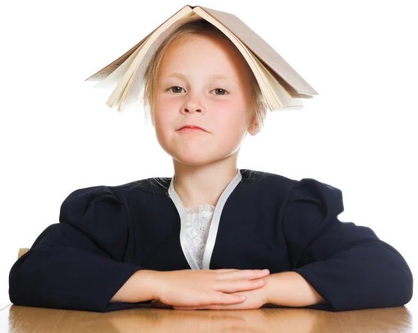 Funny schoolgirl sitting at a table — Stock Photo, Image