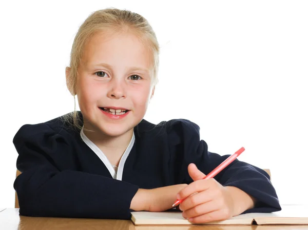 Schoolgirl writes at a table Stock Picture