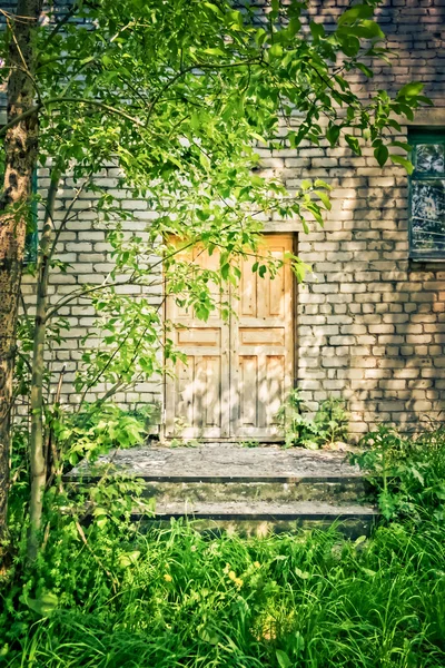 Holztür in einem alten Backsteingebäude — Stockfoto