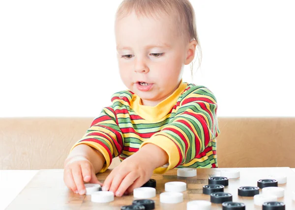 Kid playing checkers. — Stock Photo, Image
