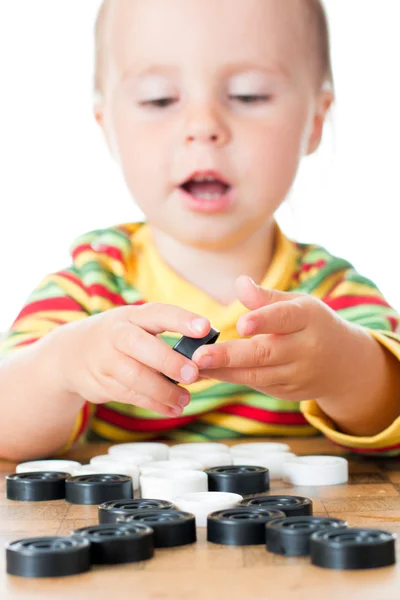 Kid playing checkers. — Stock Photo, Image
