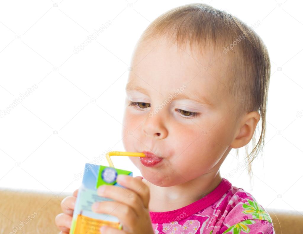Baby drinking juice from straw