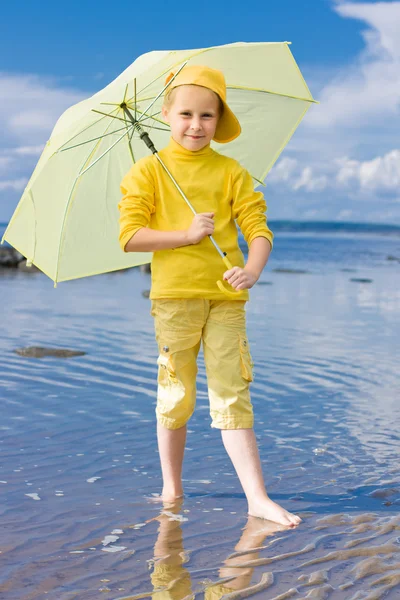 Girl with umbrella on a beach — Stock Photo, Image