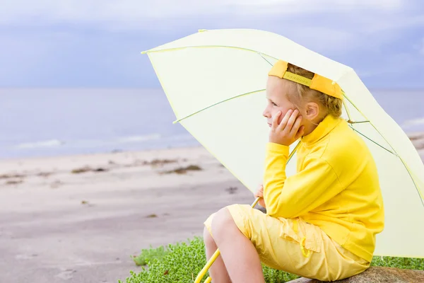Girl with umbrella on a beach — Stock Photo, Image
