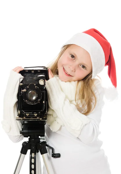 Chica en un disfraz de Navidad con cámara vieja — Foto de Stock