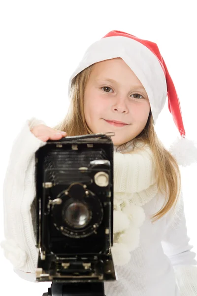 Menina em um traje de Natal com câmera velha — Fotografia de Stock