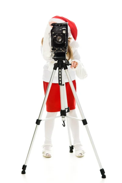 Chica en un disfraz de Navidad con cámara vieja — Foto de Stock