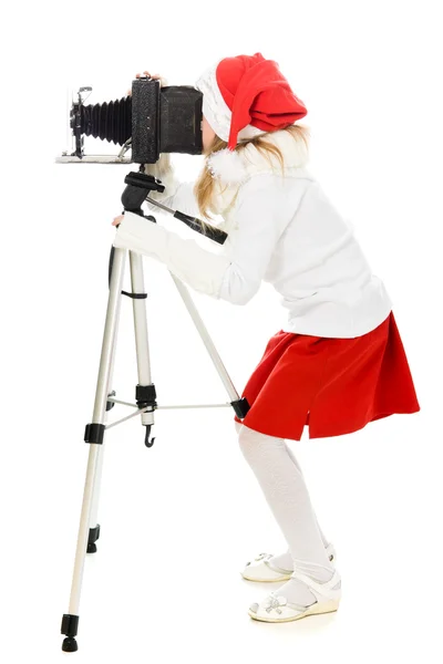 Girl in a Christmas costume with old camera — Stock Photo, Image