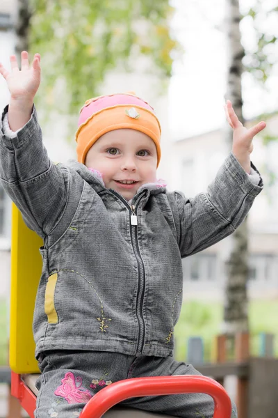 Laughing child on swing — Stock Photo, Image