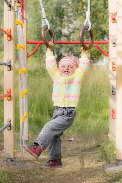 Laughing child on sports rings — Stock Photo, Image