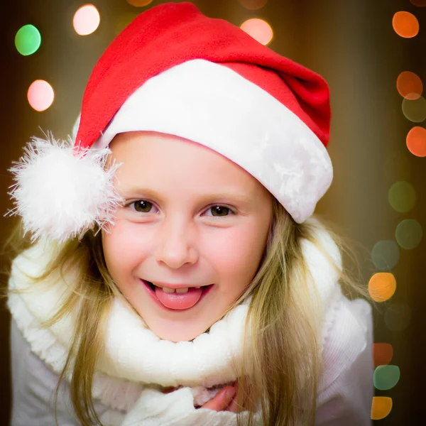 Smiling girl in santa hat Stock Image