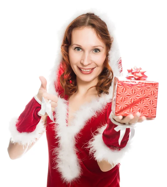 Boldog lány egy karácsonyi ruha rendben jel mutatja — Stock Fotó
