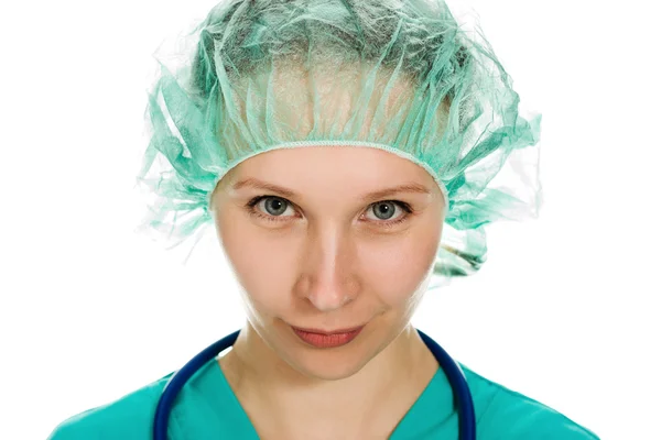 Beautiful woman surgeon angrily looks — Stock Photo, Image