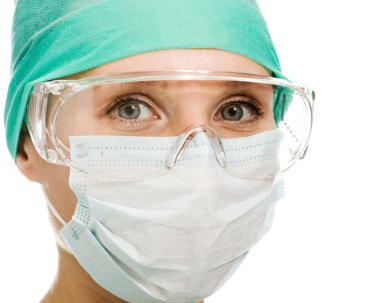 Surgeon woman in protective glasses and mask