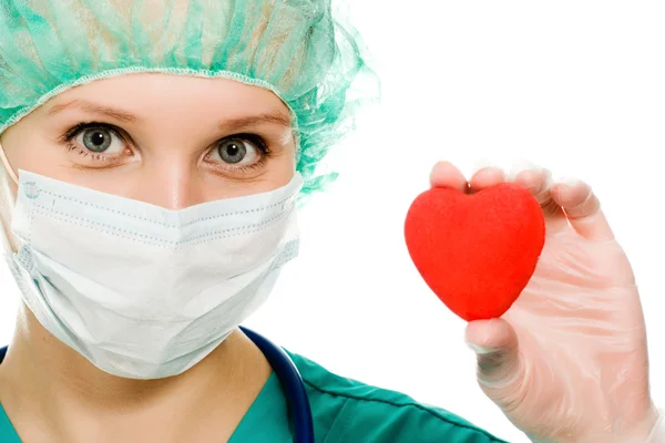 Woman doctor with a heart in his hands — Stock Photo, Image