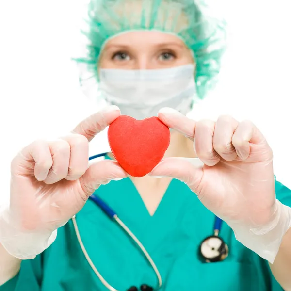 Женщина-врач с сердцем в руках — стоковое фото