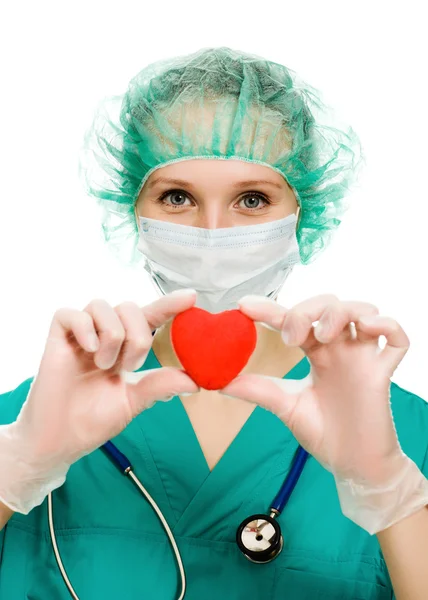 Woman doctor with a heart in his hands — Stock Photo, Image