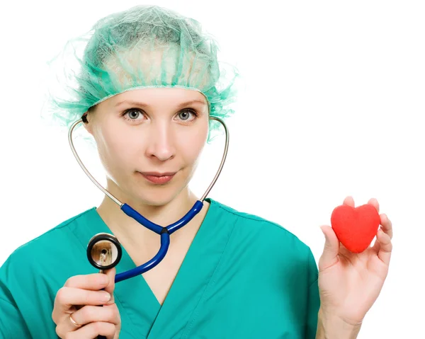 Woman doctor with stethoscope and heart in hands — Stock Photo, Image