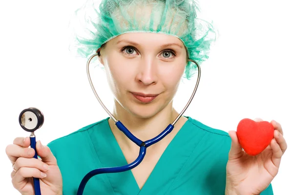 Woman doctor with stethoscope and heart in hands — Stock Photo, Image